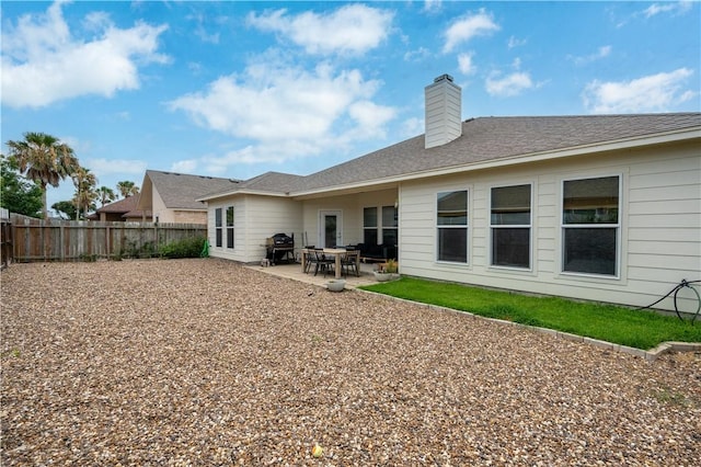 15114 Barataria Dr, Corpus Christi, TX 78418 - back of house with a fenced backyard, a patio area, and a chimney