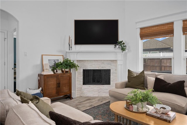 15114 Barataria Dr, Corpus Christi, TX 78418 - living area with wood finished floors, arched walkways, and a brick fireplace