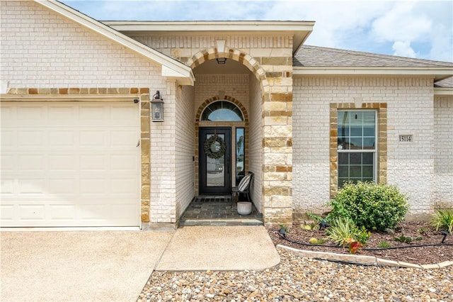 15114 Barataria Dr, Corpus Christi, TX 78418 - view of exterior entry with brick siding, an attached garage, and driveway