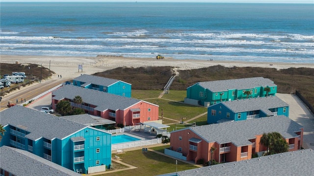 drone / aerial view with a water view and a view of the beach