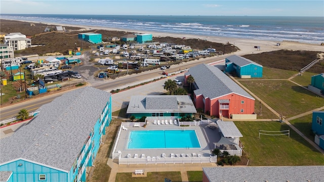 drone / aerial view featuring a water view and a beach view