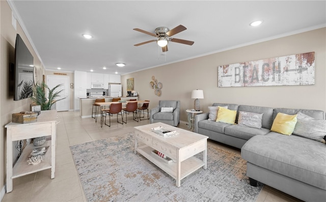 living room with ceiling fan, light tile patterned floors, and crown molding