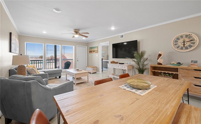 dining area with ceiling fan and crown molding