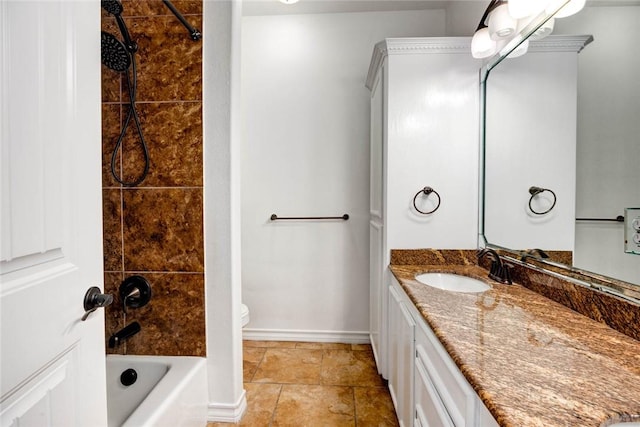 full bathroom featuring vanity, tiled shower / bath combo, and toilet