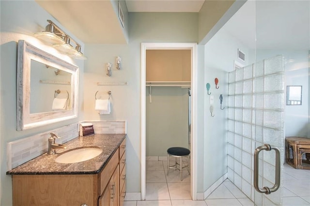 bathroom with tile patterned floors, vanity, and decorative backsplash