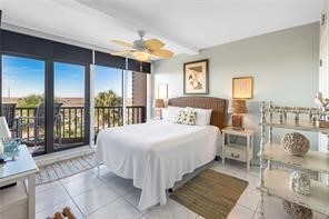 tiled bedroom featuring access to outside and beam ceiling