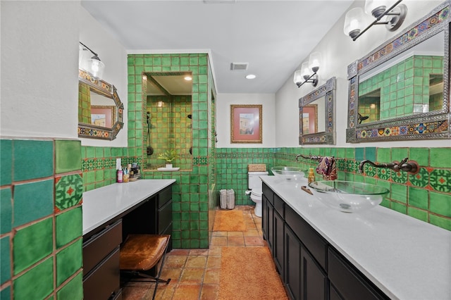 bathroom featuring vanity, a shower, toilet, and tile walls