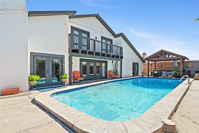 view of pool with a gazebo, outdoor lounge area, a patio, and french doors