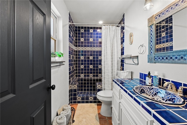 bathroom with tile patterned flooring, a shower with curtain, vanity, and toilet