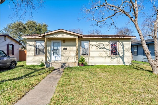 bungalow-style house featuring a front yard