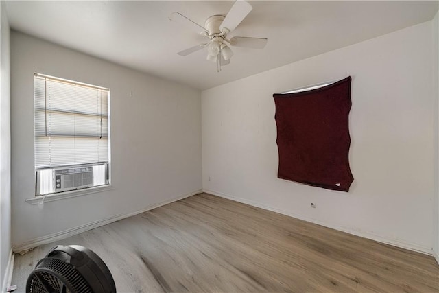 unfurnished room with cooling unit, ceiling fan, and light hardwood / wood-style flooring