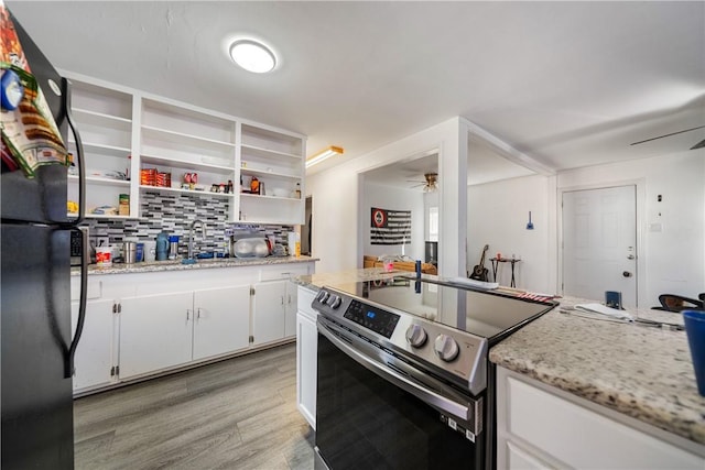 kitchen with ceiling fan, stainless steel electric stove, light stone countertops, and white cabinets