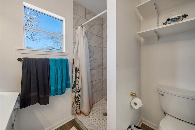 bathroom with walk in shower and toilet