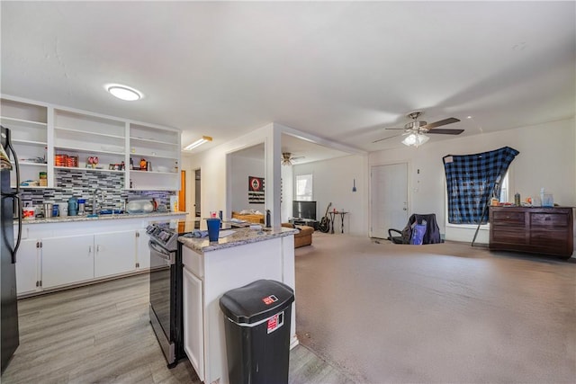 kitchen featuring white cabinetry, tasteful backsplash, stainless steel electric range oven, light stone counters, and ceiling fan