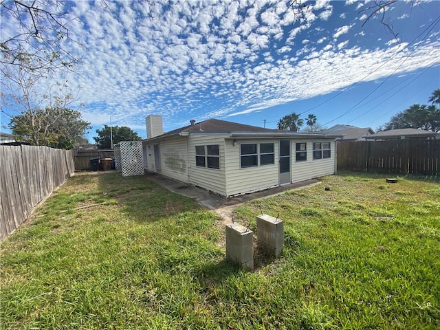 back of property featuring a lawn