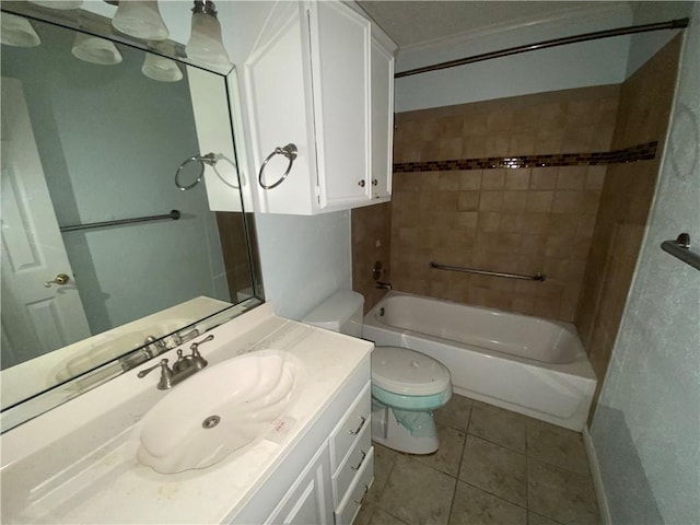 full bathroom featuring toilet, crown molding, tile patterned floors, tiled shower / bath, and vanity