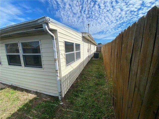 view of side of property featuring central air condition unit