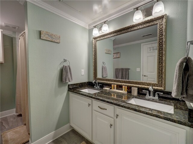 bathroom with ornamental molding and vanity