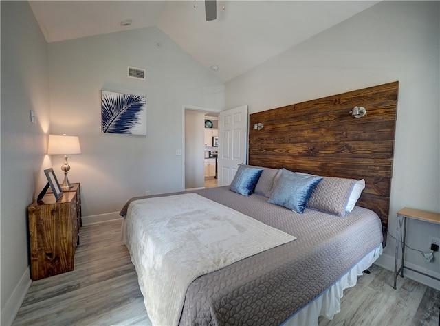 bedroom featuring high vaulted ceiling, ceiling fan, and light hardwood / wood-style flooring