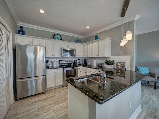 kitchen featuring stainless steel appliances, white cabinetry, and kitchen peninsula