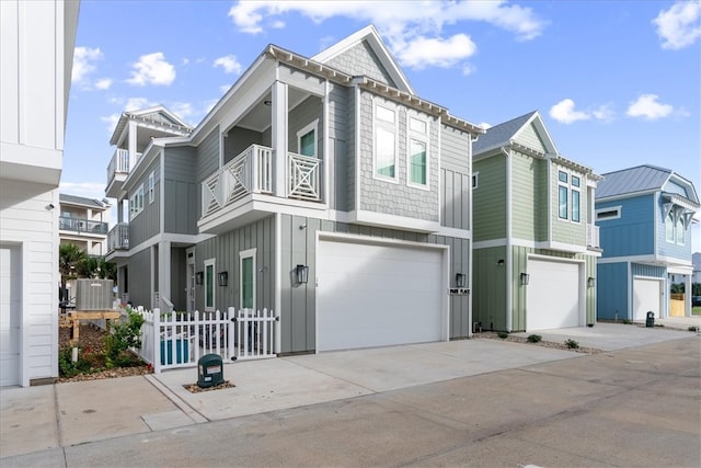 view of front of property featuring a garage and a balcony