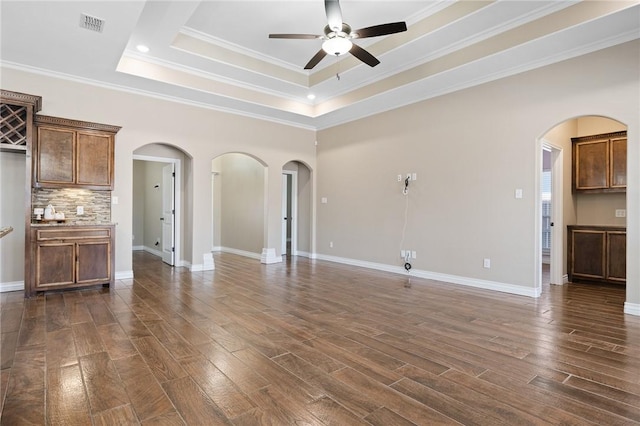 7918 Stampede Dr, Corpus Christi, TX 78414 - unfurnished living room with visible vents, arched walkways, ceiling fan, and dark wood finished floors
