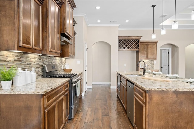 7918 Stampede Dr, Corpus Christi, TX 78414 - kitchen with dark wood-style floors, a sink, arched walkways, crown molding, and appliances with stainless steel finishes