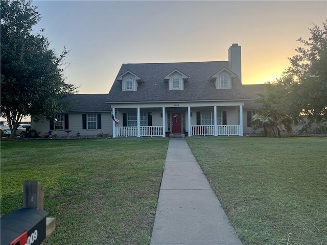 6009 King Trl, Corpus Christi, TX 78414 - cape cod house featuring covered porch, a front lawn, a chimney, and a shingled roof