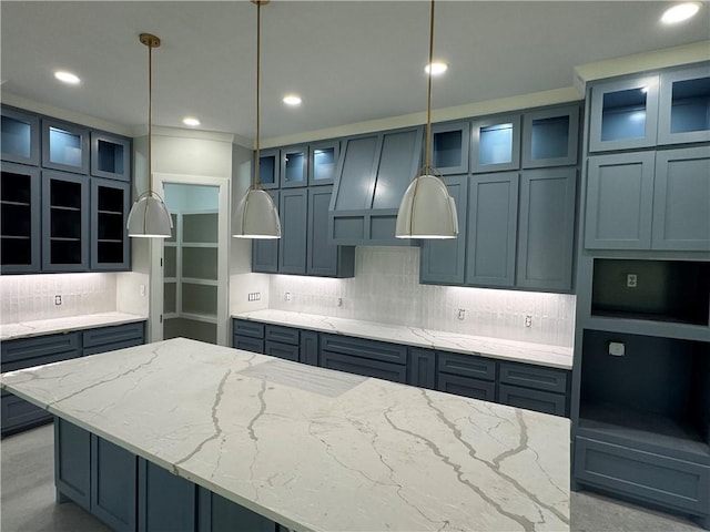2425 Manuel, Corpus Christi, TX 78414 - kitchen featuring decorative backsplash, light stone countertops, hanging light fixtures, recessed lighting, and glass insert cabinets