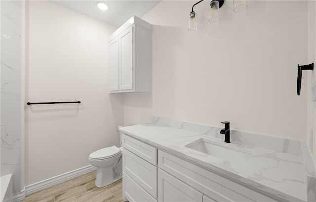 bathroom featuring hardwood / wood-style floors, vanity, and toilet