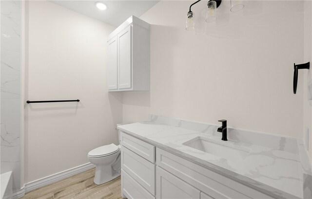 4133 Azali Dr, Corpus Christi, TX 78414 - bathroom featuring wood finished floors, toilet, vanity, a tub, and a shower