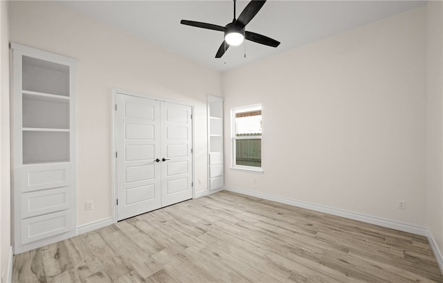 unfurnished bedroom featuring ceiling fan, light wood-type flooring, and a closet