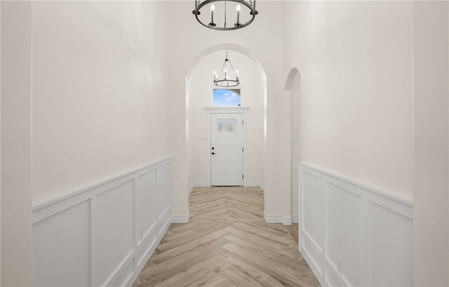 4133 Azali Dr, Corpus Christi, TX 78414 - entryway featuring a chandelier, wainscoting, a decorative wall, and arched walkways