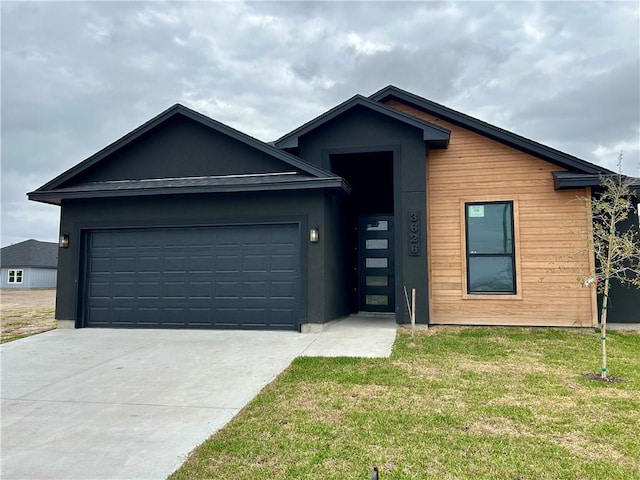 view of front of home with driveway, a front lawn, and an attached garage