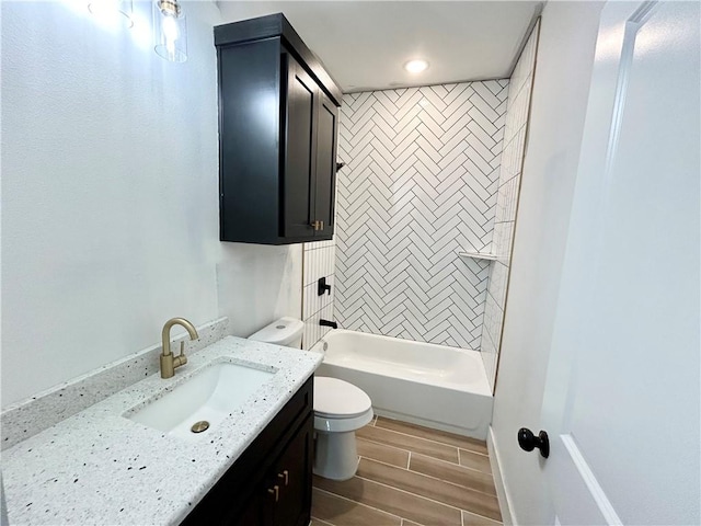 full bathroom featuring baseboards, toilet, wood tiled floor, vanity, and shower / bathing tub combination