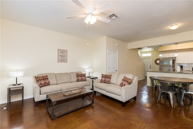 living room with ceiling fan and sink