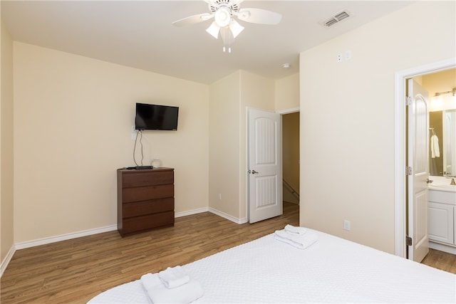 bedroom with ensuite bathroom, ceiling fan, and light hardwood / wood-style floors