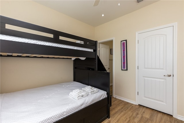 bedroom with light hardwood / wood-style floors and ceiling fan