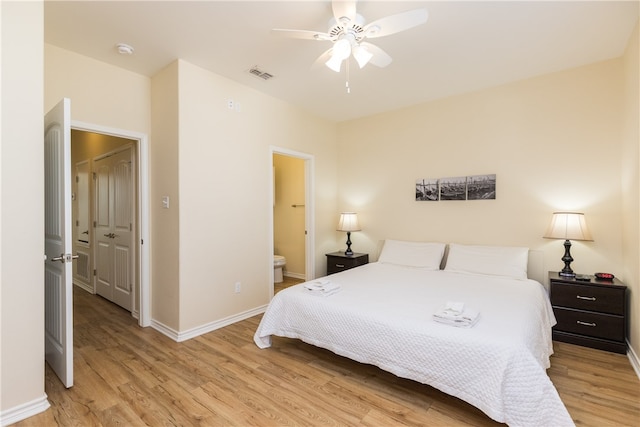 bedroom featuring ensuite bath, ceiling fan, and light hardwood / wood-style flooring