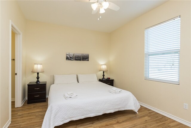 bedroom with ceiling fan and light wood-type flooring