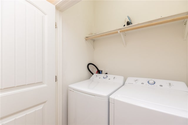 clothes washing area featuring independent washer and dryer