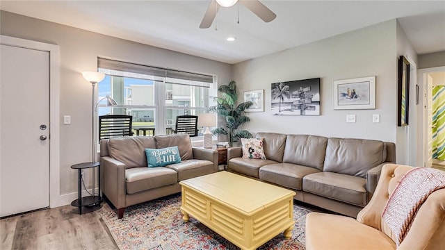 living room featuring recessed lighting, ceiling fan, light wood-style flooring, and baseboards