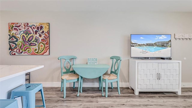 dining area featuring baseboards and wood finished floors