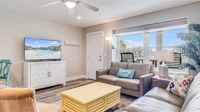 living area featuring ceiling fan, wood finished floors, and baseboards