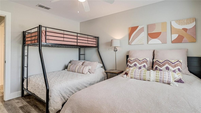 bedroom with visible vents, ceiling fan, baseboards, and wood finished floors