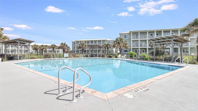 pool featuring fence and a patio