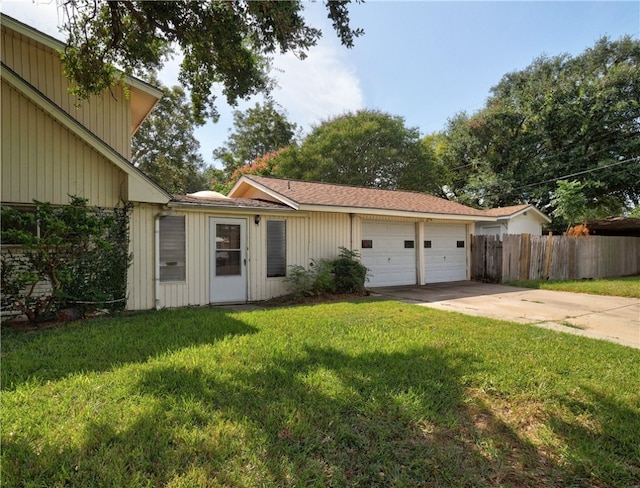 ranch-style house featuring a garage and a front lawn