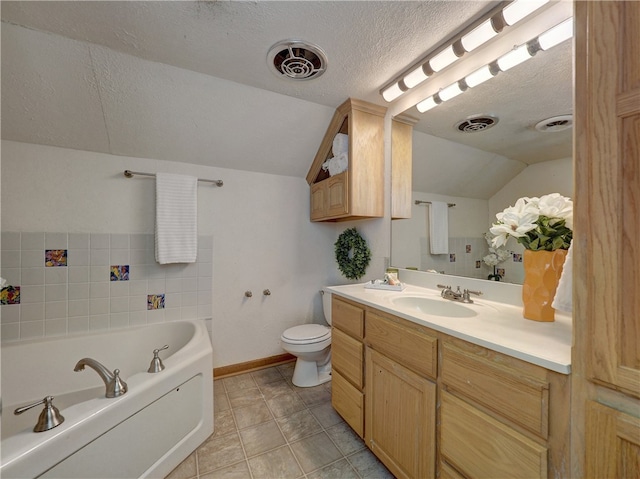 bathroom with tile patterned flooring, vanity, a textured ceiling, and vaulted ceiling