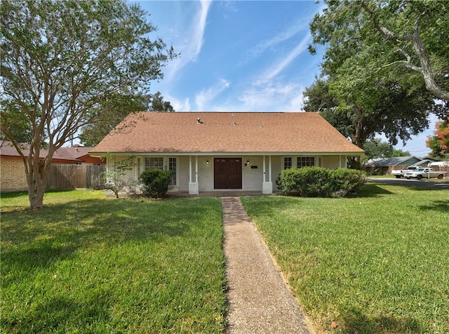 single story home featuring a front lawn