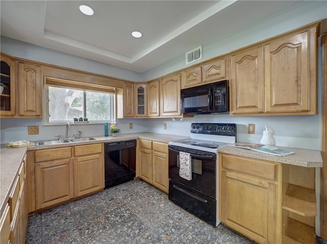 kitchen with black appliances, sink, and a raised ceiling